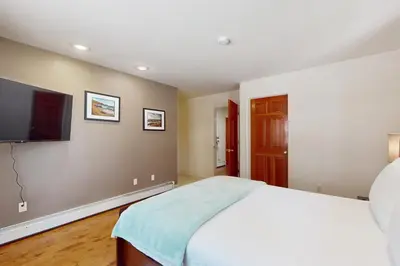 a bedroom with a bed and a flat screen tv at High Meadow Storybook in South Lake Tahoe