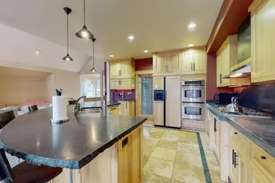 a kitchen with wooden cabinets and a large island at Charles Charmer in South Lake Tahoe