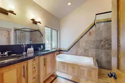 a bathroom with a tub and a sink and a shower at Charles Charmer in South Lake Tahoe