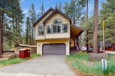 a house with a garage in a yard at Charles Charmer in South Lake Tahoe