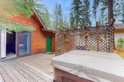 a house with a wooden deck with a bed on it at Montgomery Estates Retreat in South Lake Tahoe