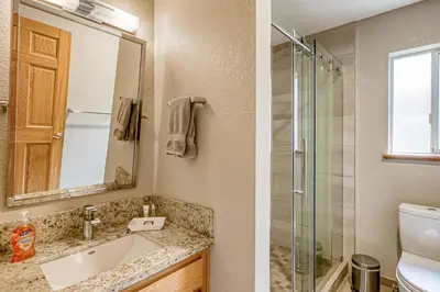 a bathroom with a sink and a glass shower at Montgomery Estates Ski & Beach Haven in South Lake Tahoe