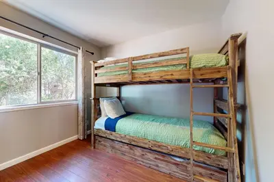 a bedroom with two bunk beds and a window at Cellador Charms in South Lake Tahoe