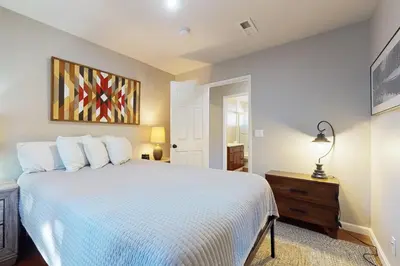 a bedroom with a white bed and a painting on the wall at Cellador Charms in South Lake Tahoe