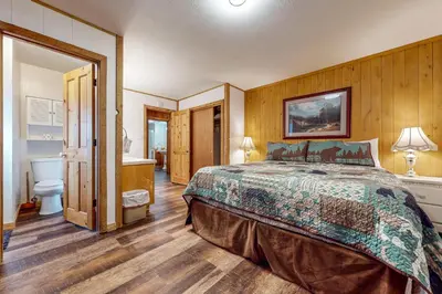 a bedroom with a large bed and a bathroom at Donner Escape in South Lake Tahoe