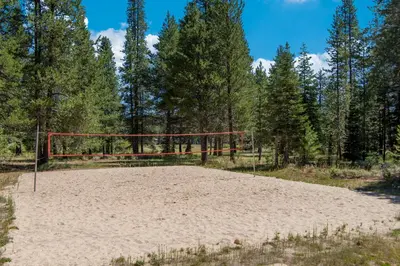 a volleyball hoop in the sand in a forest at Chamonix Escape in Truckee