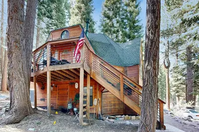 a cabin in the woods with an american flag at Chamonix Escape in Truckee