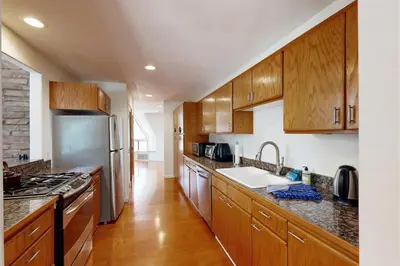 a kitchen with wooden cabinets and stainless steel appliances at Chamonix Escape in Truckee