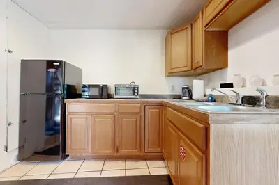 a kitchen with wooden cabinets and a stainless steel refrigerator at Chamonix Escape in Truckee