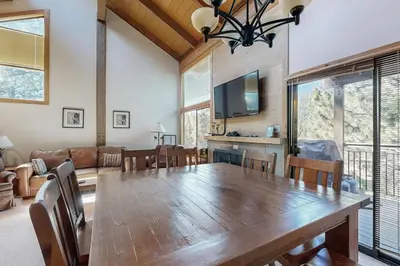 a dining room with a large wooden table and chairs at Rocky Point Charms in Truckee