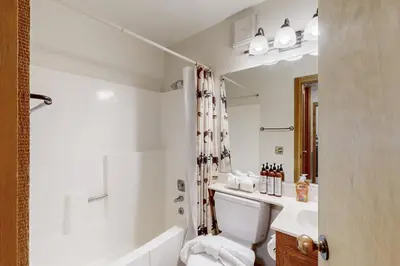 a bathroom with a tub and a toilet and a sink at Rocky Point Charms in Truckee