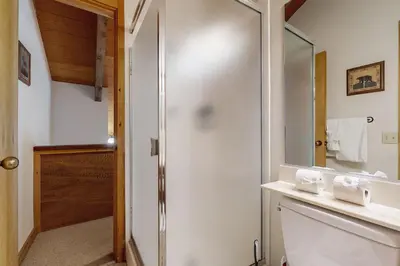 a bathroom with a shower and a sink and a mirror at Rocky Point Charms in Truckee
