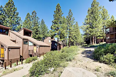 a row of homes with trees in the background at Rocky Point Charms in Truckee