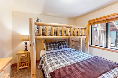 a bedroom with a bunk bed next to a window at The Bear's Lair House in Truckee