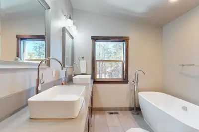 a bathroom with a large white tub and a sink at Arrowhead Adventures in South Lake Tahoe