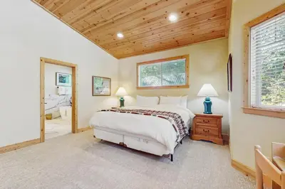 a bedroom with a large bed and a window at Willow Creek Hideway in Tahoma