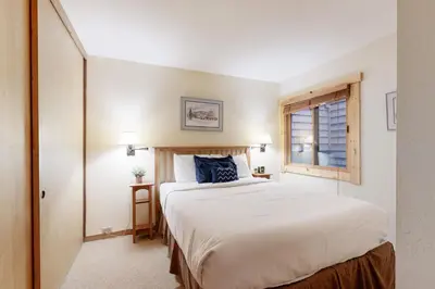 a bedroom with a large white bed and a window at Slopeside Adventures in Truckee
