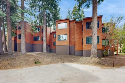 a house with trees in front of it at Slopeside Adventures in Truckee
