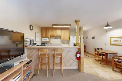 a kitchen with wooden cabinets and a counter top at Slopeside Adventures in Truckee