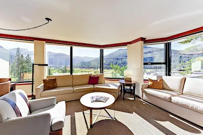 a living room with couches and large windows at Resort at Squaw Creek's 556, 558, & 560 in Olympic Valley
