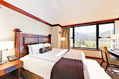 a bedroom with a bed and a desk and a window at Resort at Squaw Creek's 556, 558, & 560 in Olympic Valley