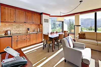 a kitchen and living room with a table and chairs at Resort at Squaw Creek's 556, 558, & 560 in Olympic Valley
