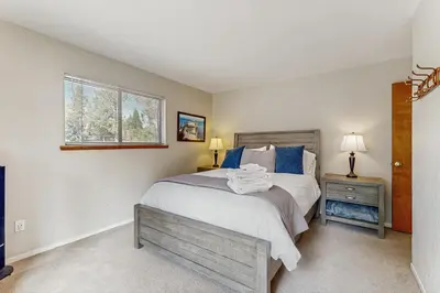 a bedroom with a large bed and a window at Azure Palace in South Lake Tahoe