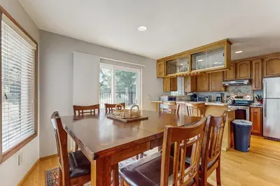 a kitchen with a large wooden table and chairs at Azure Palace in South Lake Tahoe