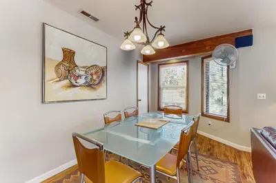 a dining room with a glass table and chairs at Azure Palace in South Lake Tahoe