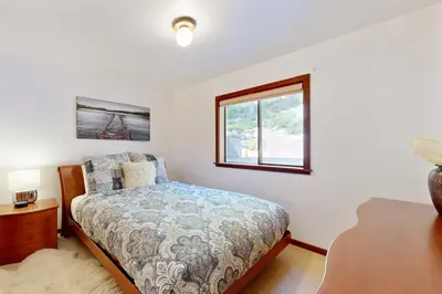 a bedroom with a bed and a window at Spectacular Lakeview Cabin in Kings Beach