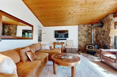 a living room with a couch and a fireplace at Spectacular Lakeview Cabin in Kings Beach
