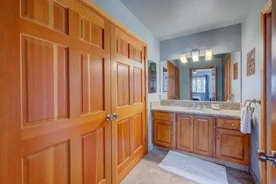 a bathroom with a sink and a large wooden door at Heaven by the Lake in Truckee