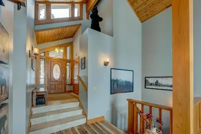 a staircase in a house with wooden ceilings at Heaven by the Lake in Truckee