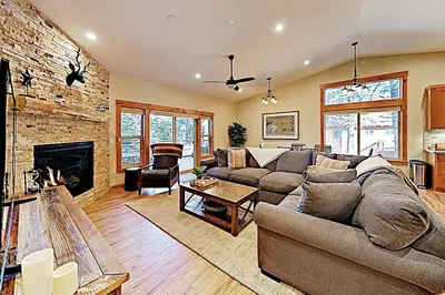 a living room with a couch and a fireplace at Thunderbird Palace in South Lake Tahoe