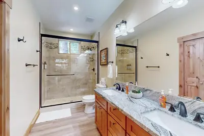 a bathroom with two sinks and a shower at Thunderbird Palace in South Lake Tahoe