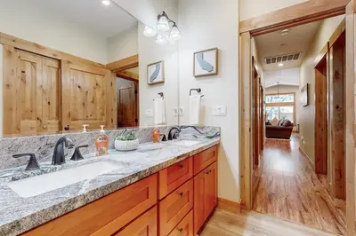 a bathroom with a sink and a large mirror at Thunderbird Palace in South Lake Tahoe