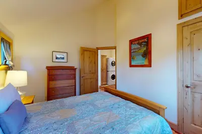 a bedroom with a bed and a dresser at Cottage Charms in South Lake Tahoe