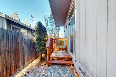 a wooden bench sitting on the side of a house at Cottage Charms in South Lake Tahoe