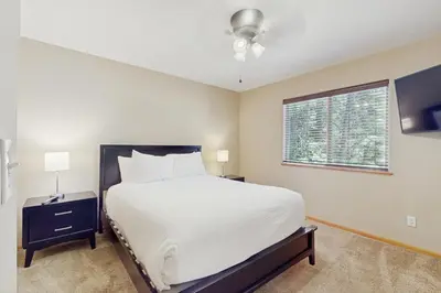 a bedroom with a large bed and a window at Backyard Oasis in South Lake Tahoe