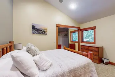 a bedroom with a white bed and a window at Cherry Hill Charms in South Lake Tahoe