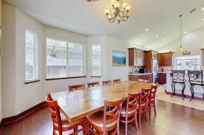 a dining room and kitchen with a wooden table and chairs at Jacarillo Escape in South Lake Tahoe
