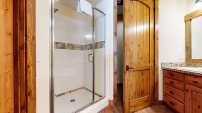 a bathroom with a shower with a glass door at Snowcreek VI The Lodges #1133 condo in Mammoth Lakes