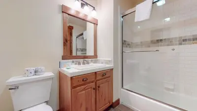 a bathroom with a toilet and a sink and a shower at Snowcreek VI The Lodges #1133 condo in Mammoth Lakes