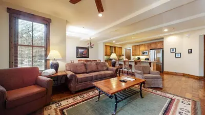 a living room with two couches and a table at Snowcreek VI The Lodges #1133 condo in Mammoth Lakes