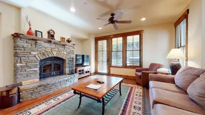 a living room with a couch and a fireplace at Snowcreek VI The Lodges #1133 condo in Mammoth Lakes