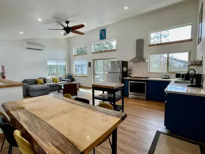 a large kitchen and living room with a ceiling fan at Ravens Lair in Yosemite West