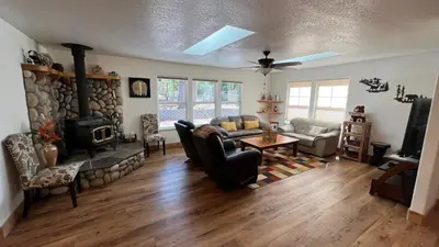 a living room with a couch and a fireplace at Cozy Cabin in Arnold ! in Arnold