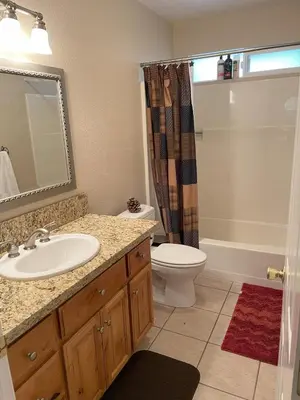 a bathroom with a sink and a toilet and a shower at Cozy Cabin in Arnold ! in Arnold