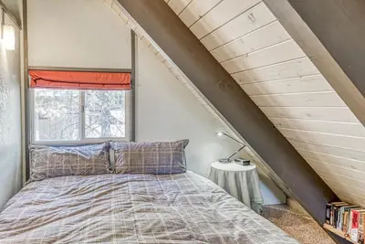 a bedroom with a bed and a window at Livin' The Dream at 7000 ft in Lakeshore