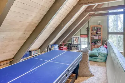 a ping pong table in a room with an attic at Livin' The Dream at 7000 ft in Lakeshore